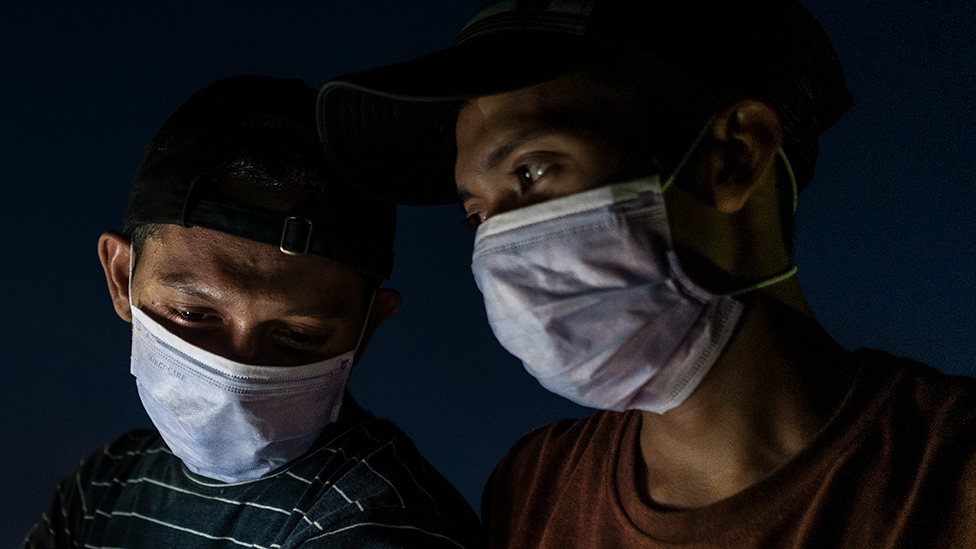 Two men wearing masks in Aceh