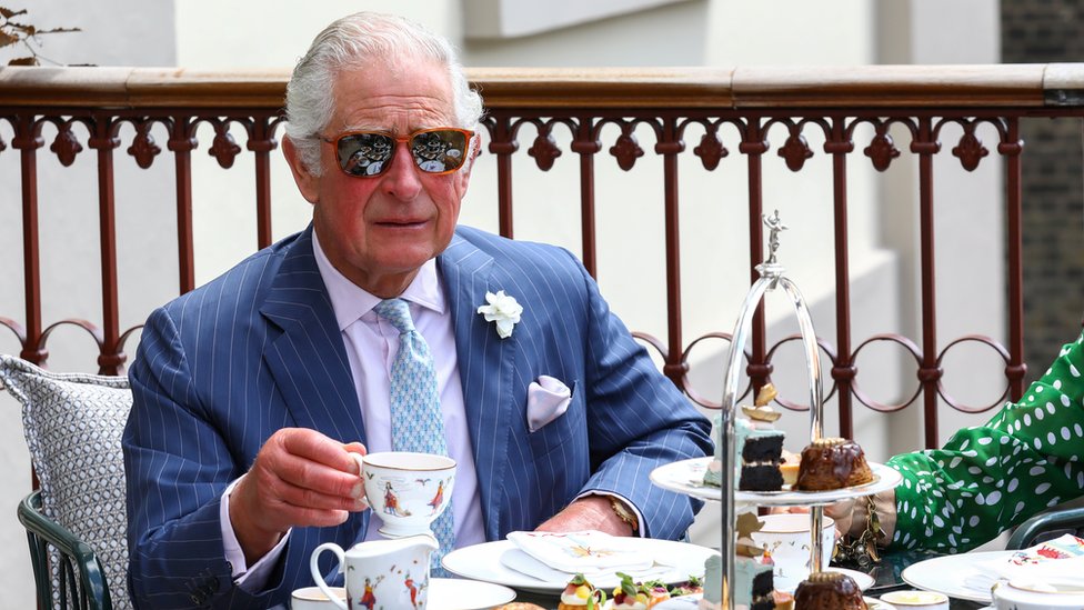 Britain"s Prince Charles drinks tea on the terrace during a visit to Theatre Royal in London,