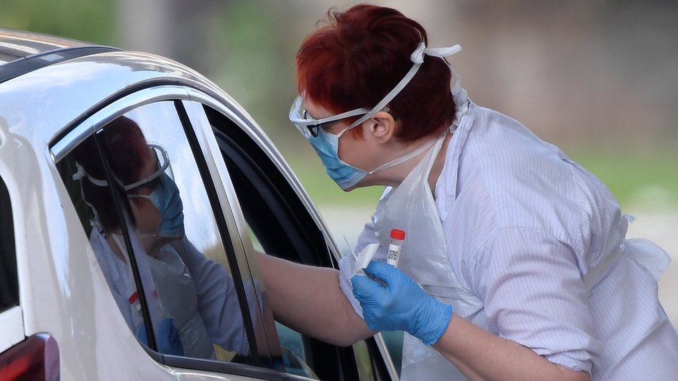 Medical staff testing people at a coronavirus test centre