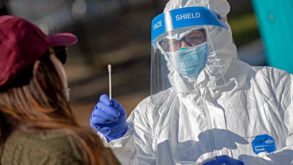 A test being conducted by a worker in PPE