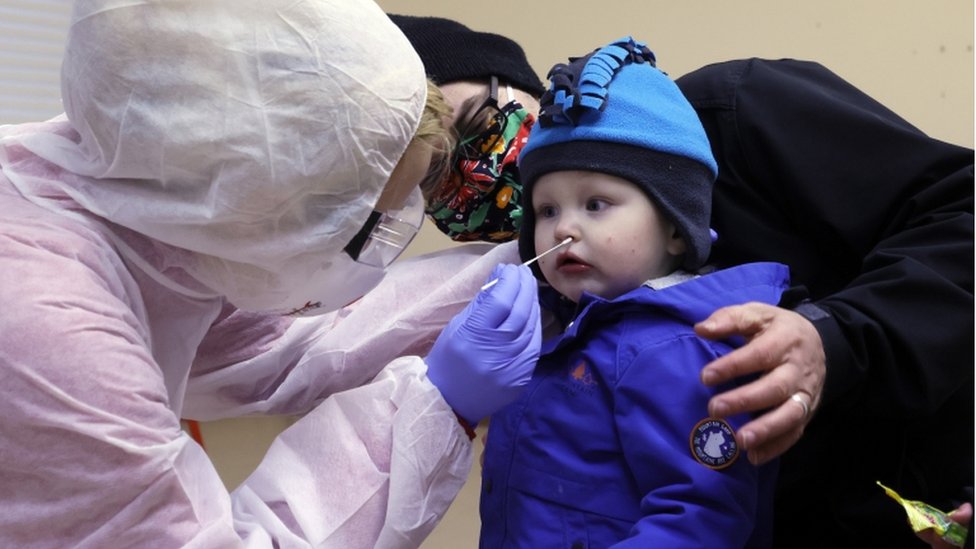 A health worker takes a swab from a child during a test in a coronavirus test station in a playschool in Hildburghausen, Germany, 01 December 2020