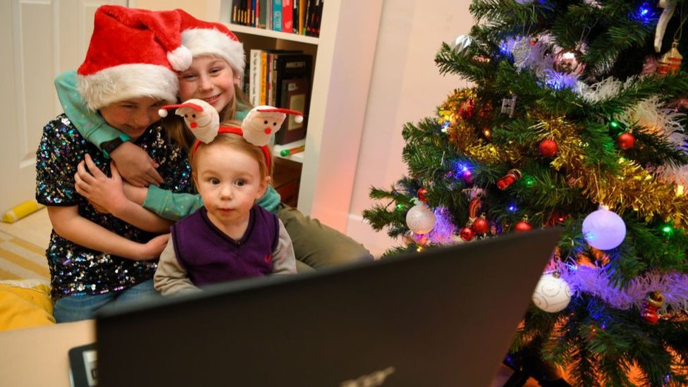 Children next to Christmas tree