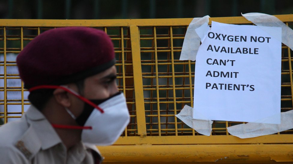 A notice pasted outside a makeshift isolation facility reads 'OXYGEN NOT AVAILABLE, CAN'T ADMIT PATIENTS', amid the rising coronavirus cases in New Delhi, India on April 23, 2021