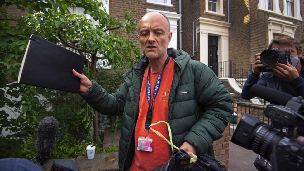 Dominic Cummings outside his house surrounded by photographers