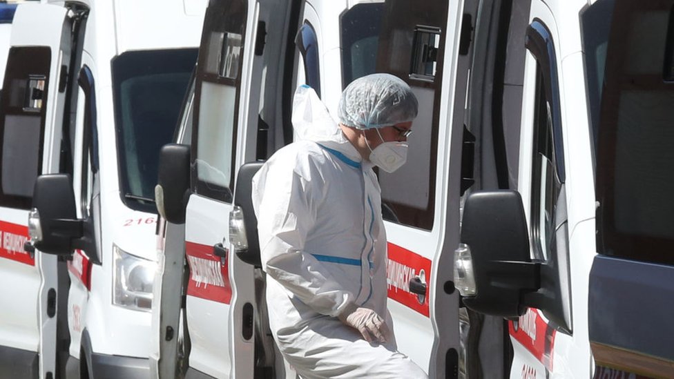 A medical worker enters an ambulance parked outside admissions at Pokrovskaya Municipal Hospital, St Petersburg