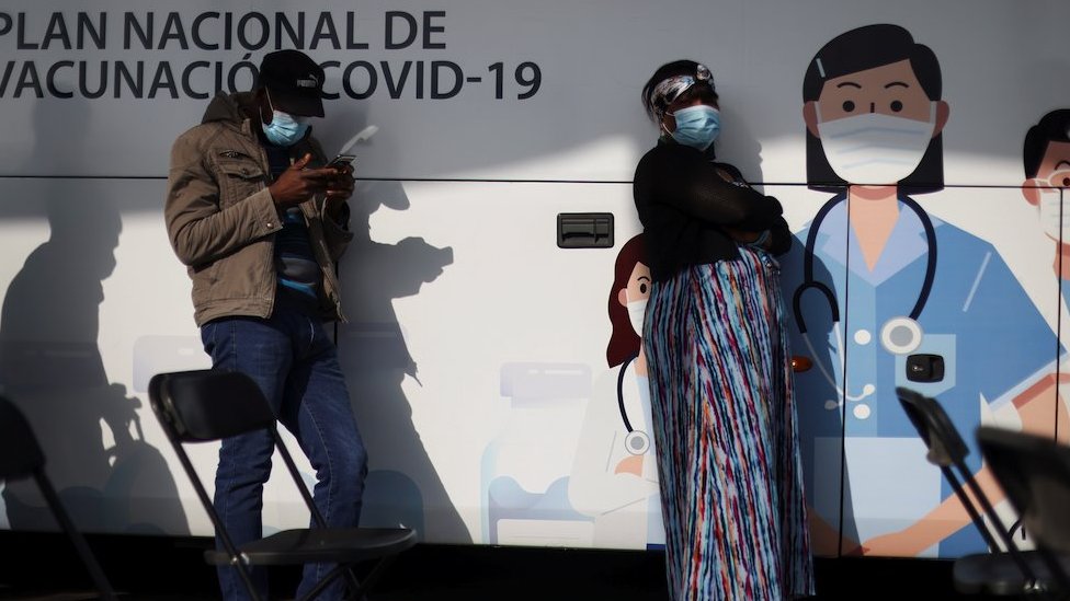 People wait outside a mobile vaccination centre to receive a dose of Sinovac"s CoronaVac vaccine against the coronavirus disease (COVID-19) in Santiago, Chile June 16, 2021.
