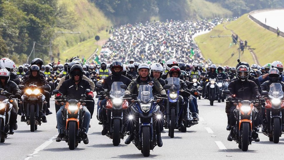 A handout photo made available by the Presidency of Brazil that shows the Brazilian President, Jair Bolsonaro (C), during a motorcycle tour with his followers, in Sao Paulo, Brazil, 12 June 2021.