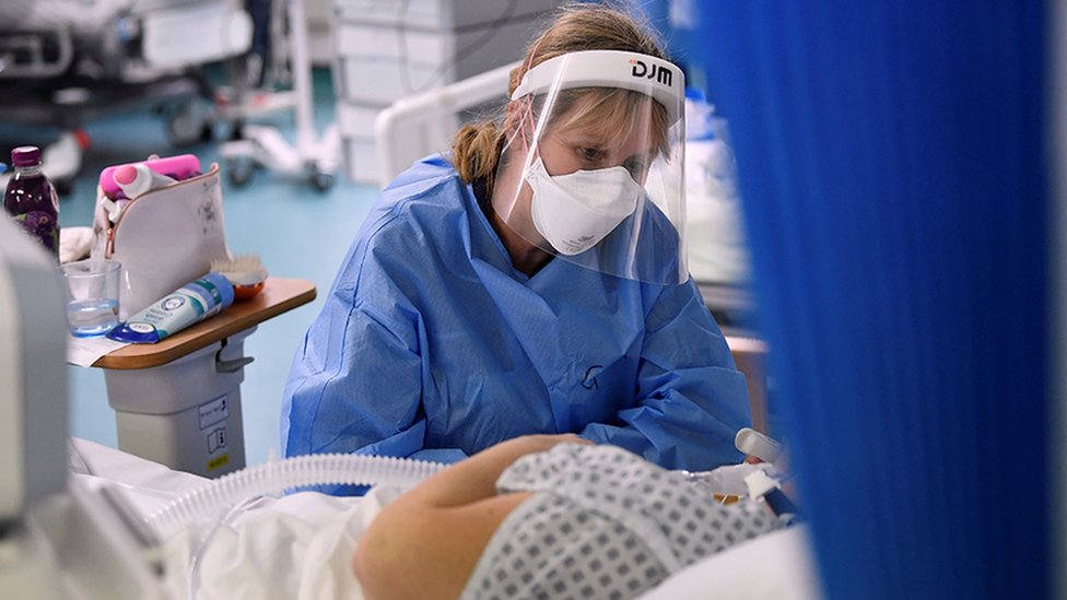 A nurse attends to a patient on a Covid-19 ward at Milton Keynes University Hospital