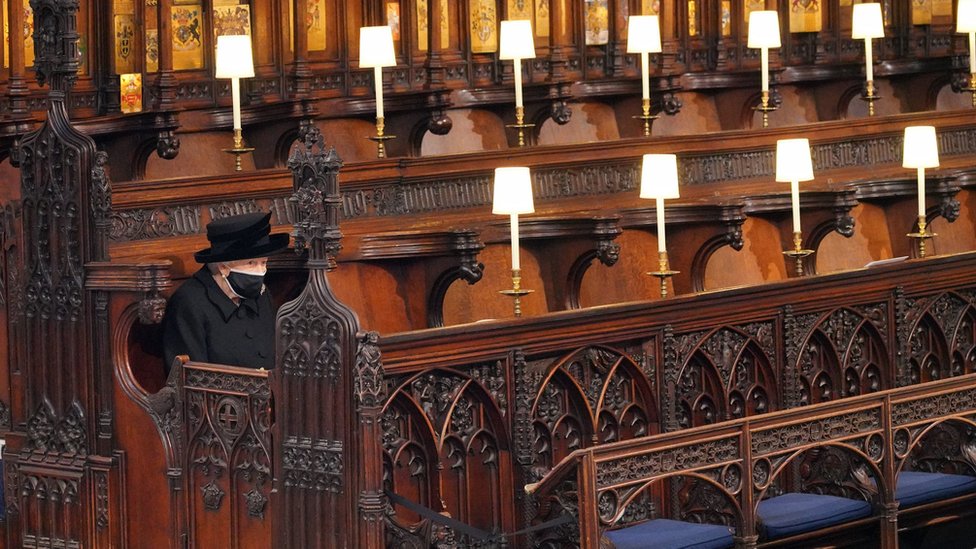 The Queen sits alone at St George's Chapel