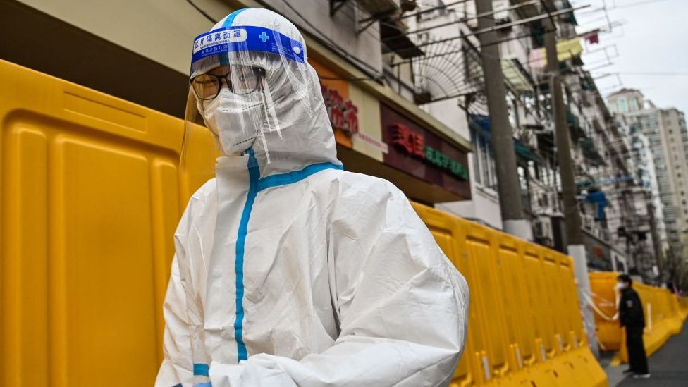 A worker, wearing a protective gear, in Shanghai